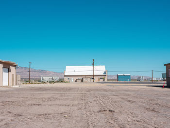 Houses and buildings against clear blue sky