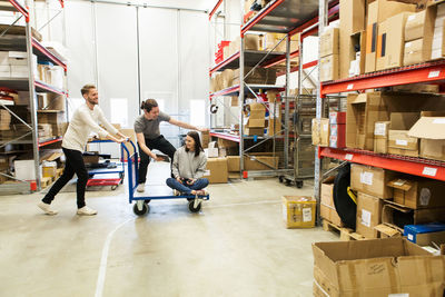 Coworkers enjoying while working at warehouse