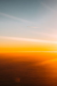 Scenic view of vapor trail in sky during sunset