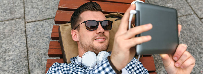 Portrait of young man using mobile phone