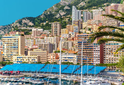 Boats moored at harbor against buildings