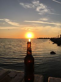 Scenic view of sea against dramatic sky during sunset