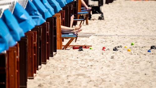 Low section of person resting on hooded beach chair