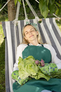 Portrait of young man sitting on hammock