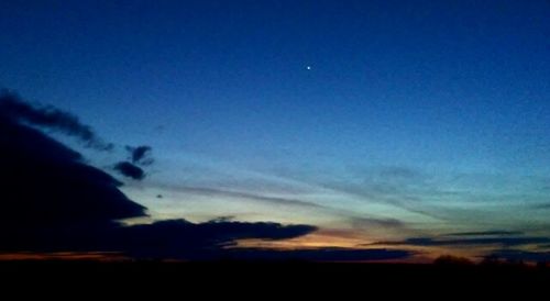 Silhouette landscape against blue sky at sunset