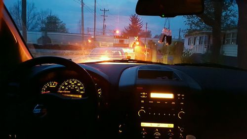 Traffic on road at sunset