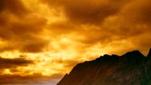 Dramatic sky over mountain during sunset