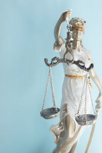 Close-up of lady justice against blue background