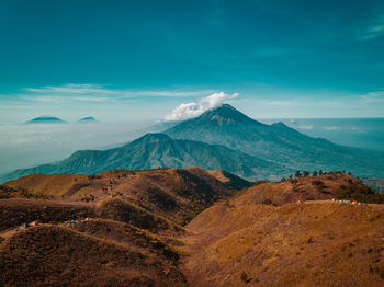 Scenic view of snowcapped mountains against blue sky