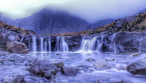 Scenic view of river flowing through rocks