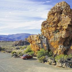 Scenic view of rocky mountains against cloudy sky