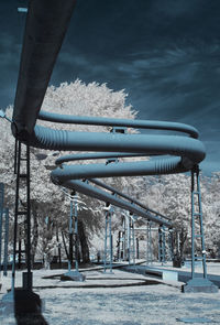 Snow covered metal structure against sky during winter infrared 