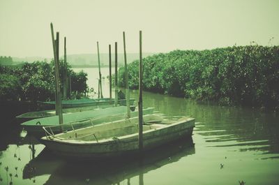 Boats moored in river