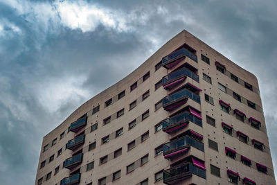 Low angle view of building against cloudy sky