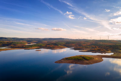 Drone aerial view of a lake reservoir of a dam with reflection on the water in sabugal, portugal