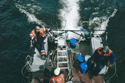 High angle view of people on boat in sea