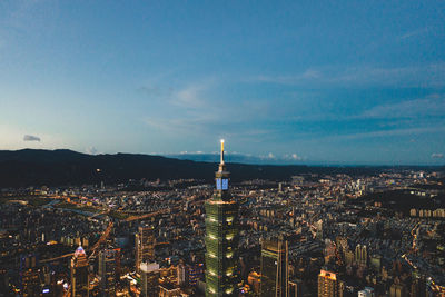 High angle view of city lit up at dusk