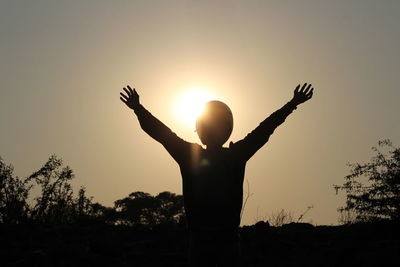 Low angle view of silhouette hand against sky during sunset