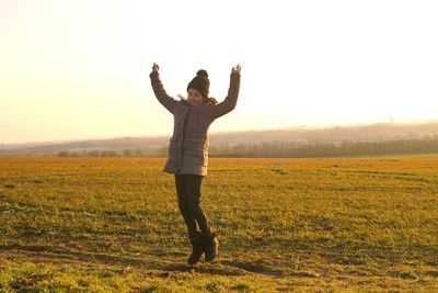 Full length of man on field against sky at sunset