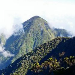 Scenic view of mountains against cloudy sky