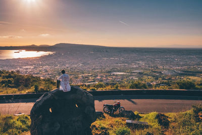 Rear view of man looking at sunset