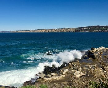 Scenic view of sea against clear blue sky