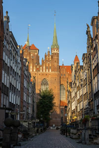 Street amidst buildings against sky in city