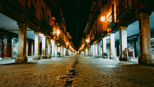 Illuminated corridor of building at night