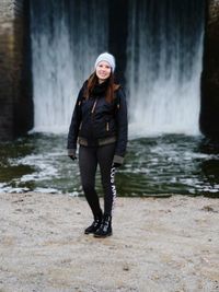 Full length portrait of woman standing in water