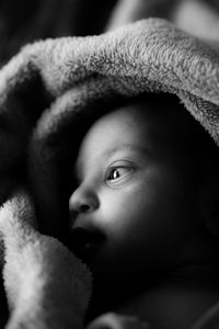 Close-up of cute baby girl in blanket
