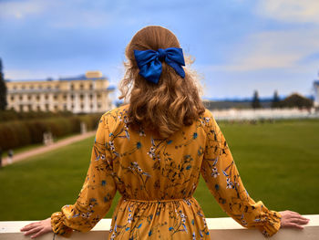 Rear view of woman standing on field