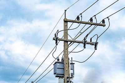 Low angle view of electricity pylon against sky