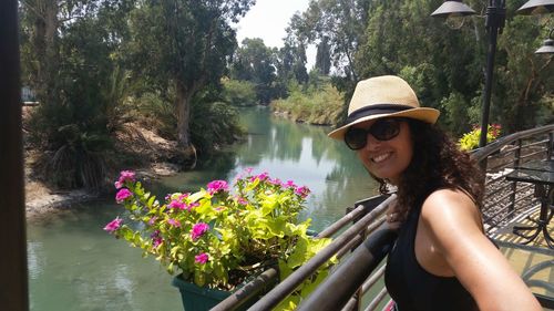 Portrait of smiling woman in balcony by river