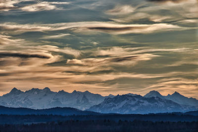 Scenic view of snowcapped mountains against sky during sunset