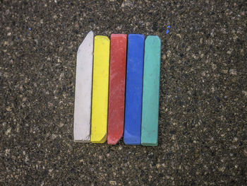 High angle view of multi colored chalks on road