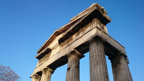 Low angle view of old temple against clear blue sky