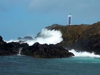 Scenic view of sea and rocks against sky