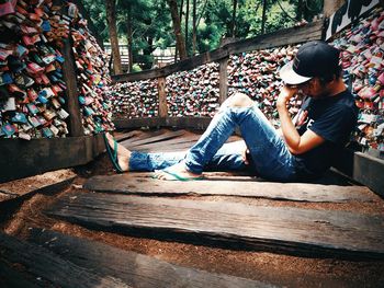 Side view of young man sitting outdoors