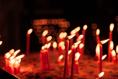 Close-up of lit candles in temple