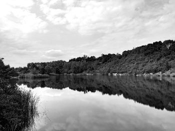 Reflection of trees in lake against sky