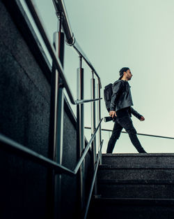 Low angle view of man standing on staircase