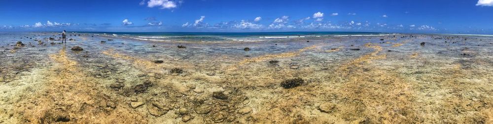 Scenic view of beach against blue sky