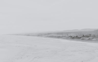 Scenic view of landscape against clear sky during winter