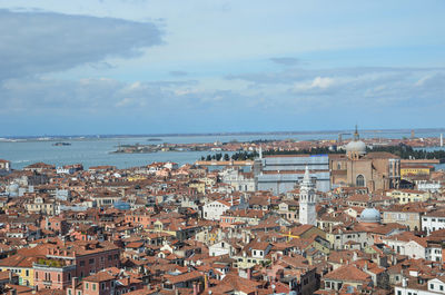 High angle view of townscape by sea against sky