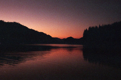 Scenic shot of calm lake at sunset