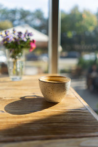 White coffee cup on wooden table in cafe