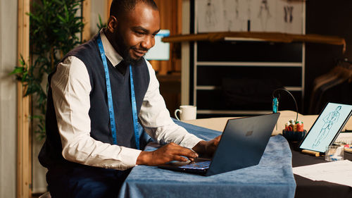 Young man using laptop while sitting at home