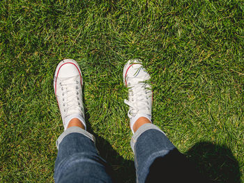 Low section of person standing on field
