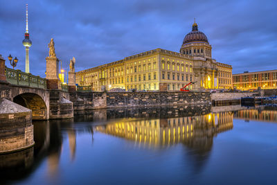 The reconstructed berlin city palace with the television tower at night