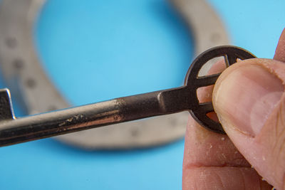 Close-up of hand holding metal